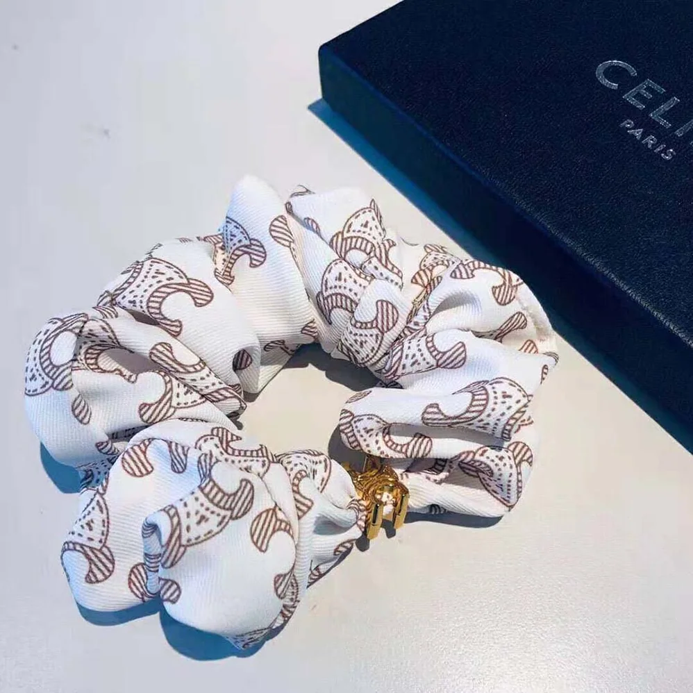 Celine Scrunchy Celine Triomphe Monogram Bracelet in Brass with Gold Finish and White Silk for Women Celine Scrunchy Celine Triomphe Monogram Bracelet in Brass with Gold Finish and White Silk for Women
