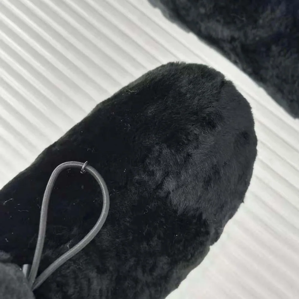 Prada Shearling Booties with Enameled Metal Triangle Logo for Women in Black