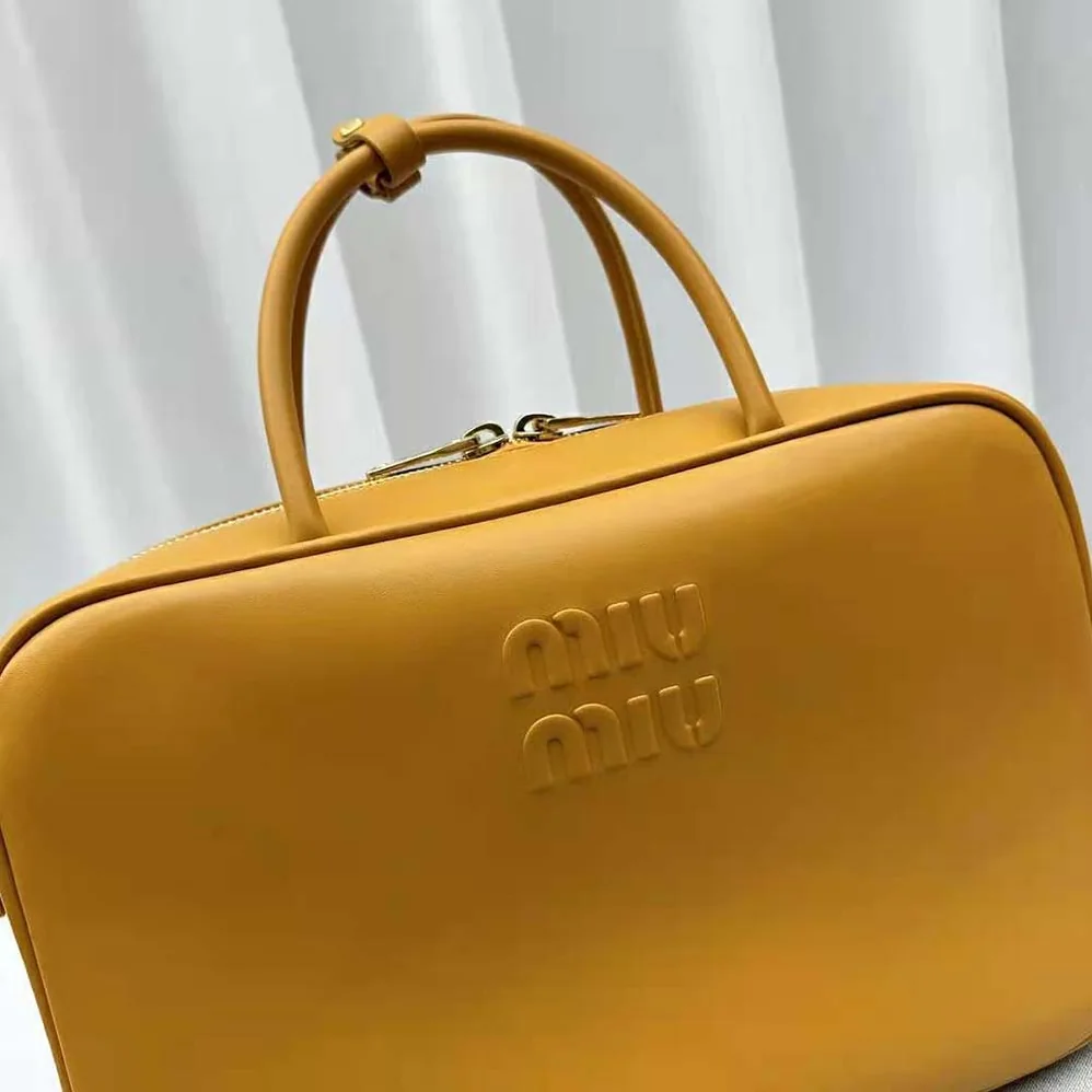 Miu Miu Leather Top-handle Bag with Embossed Lettering Logo for Women in Orange Miu Miu Leather Top-handle Bag with Embossed Lettering Logo for Women in Orange