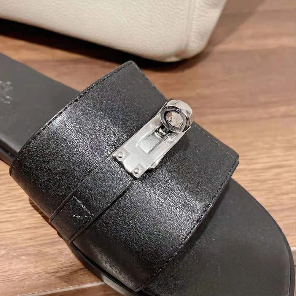 Hermes Giulia Sandal in Calfskin with Iconic Palladium-Plated Kelly Buckle for Women in Black Hermes Giulia Sandal in Calfskin with Iconic Palladium-Plated Kelly Buckle for Women in Black