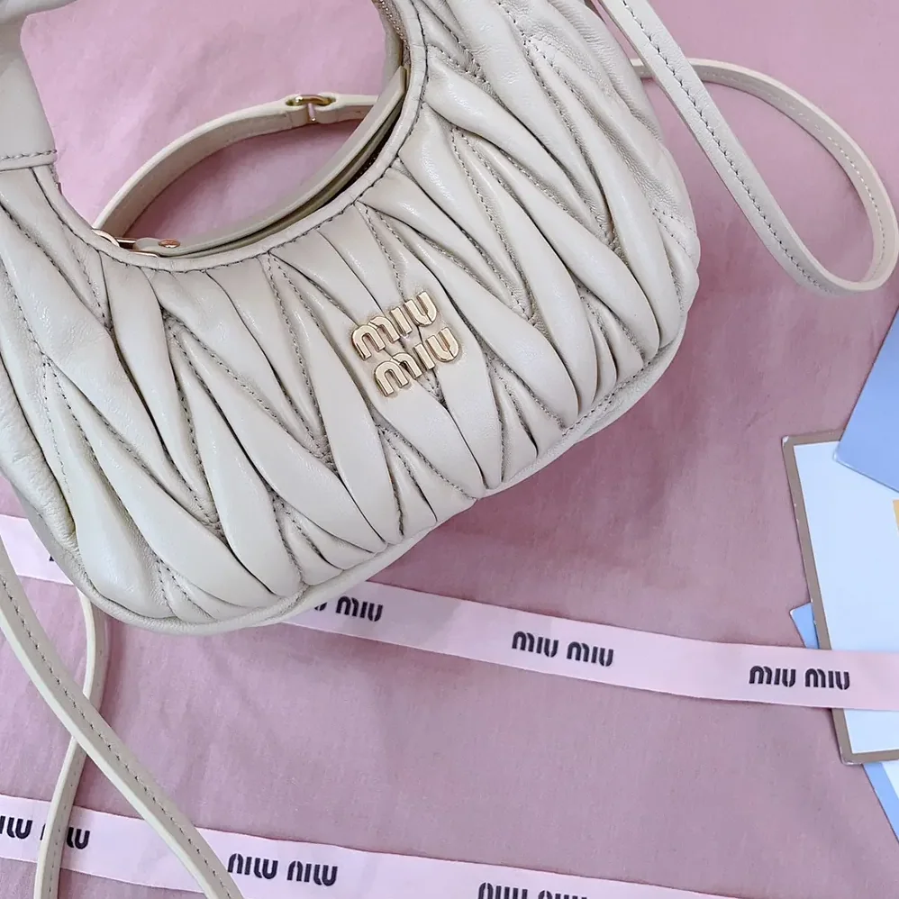 Miu Miu Wander Matelassé Nappa Leather Hobo Mini-Bag for Women in Light Yellow Miu Miu Wander Matelassé Nappa Leather Hobo Mini-Bag for Women in Light Yellow