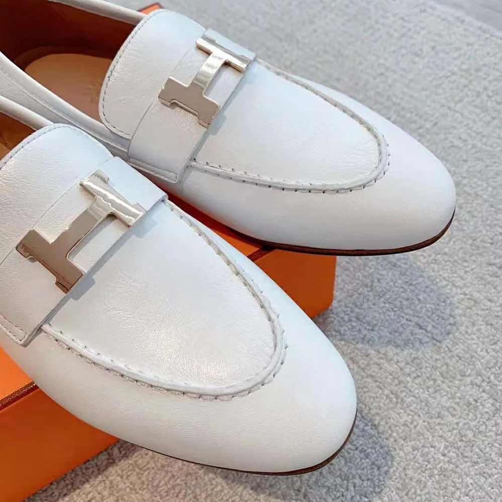 Hermes Paris Loafer in Calfskin with Palladium Plated Signature “H” Detail for Women in White Hermes Paris Loafer in Calfskin with Palladium Plated Signature “H” Detail for Women in White