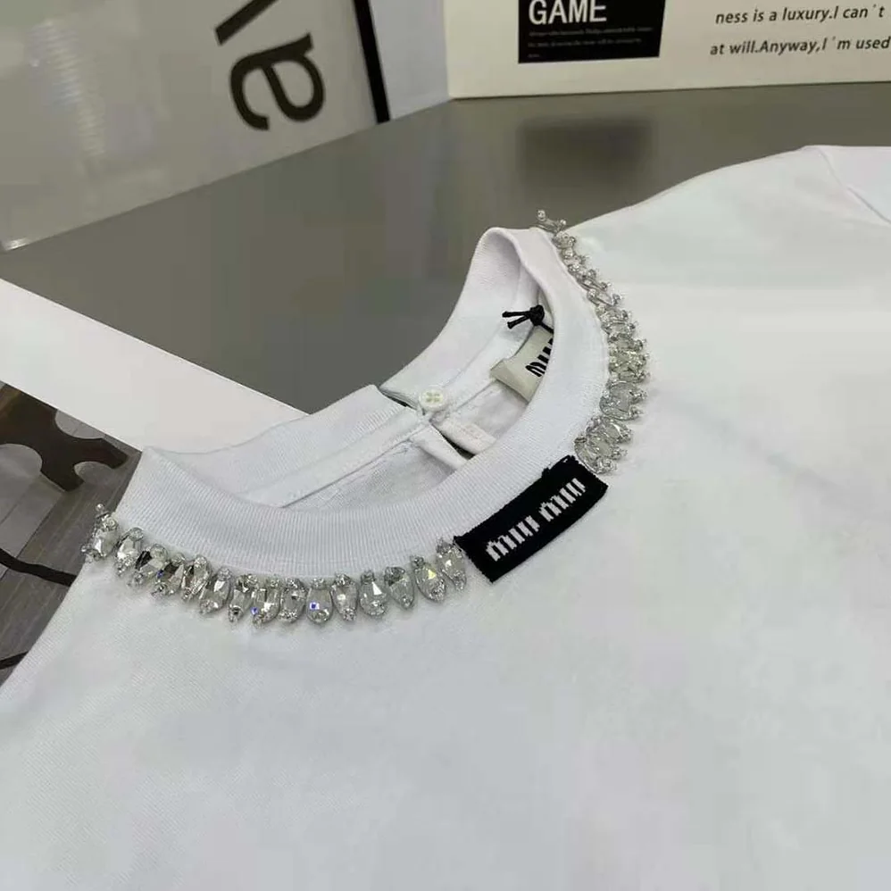 Miu Miu Embroidered Cotton T-shirt with Logo Patch for Women in White Miu Miu Embroidered Cotton T-shirt with Logo Patch for Women in White