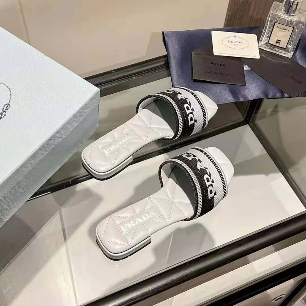 Prada Embroidered Fabric Slides With Embroidered Lettering Logo for Women in White Prada Embroidered Fabric Slides With Embroidered Lettering Logo for Women in White