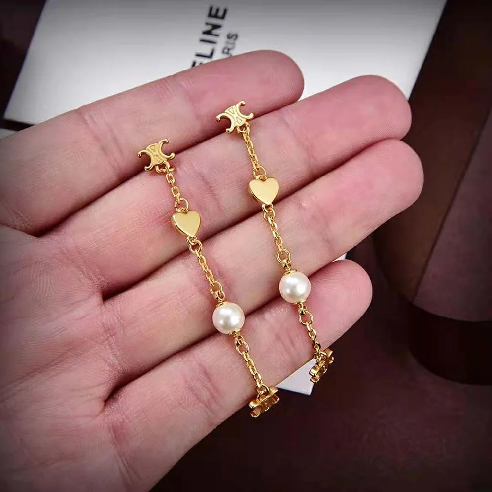 Celine Cœur Celine Charms Earrings in Brass with Gold Finish and Resin Pearl for Women Celine Cœur Celine Charms Earrings in Brass with Gold Finish and Resin Pearl for Women