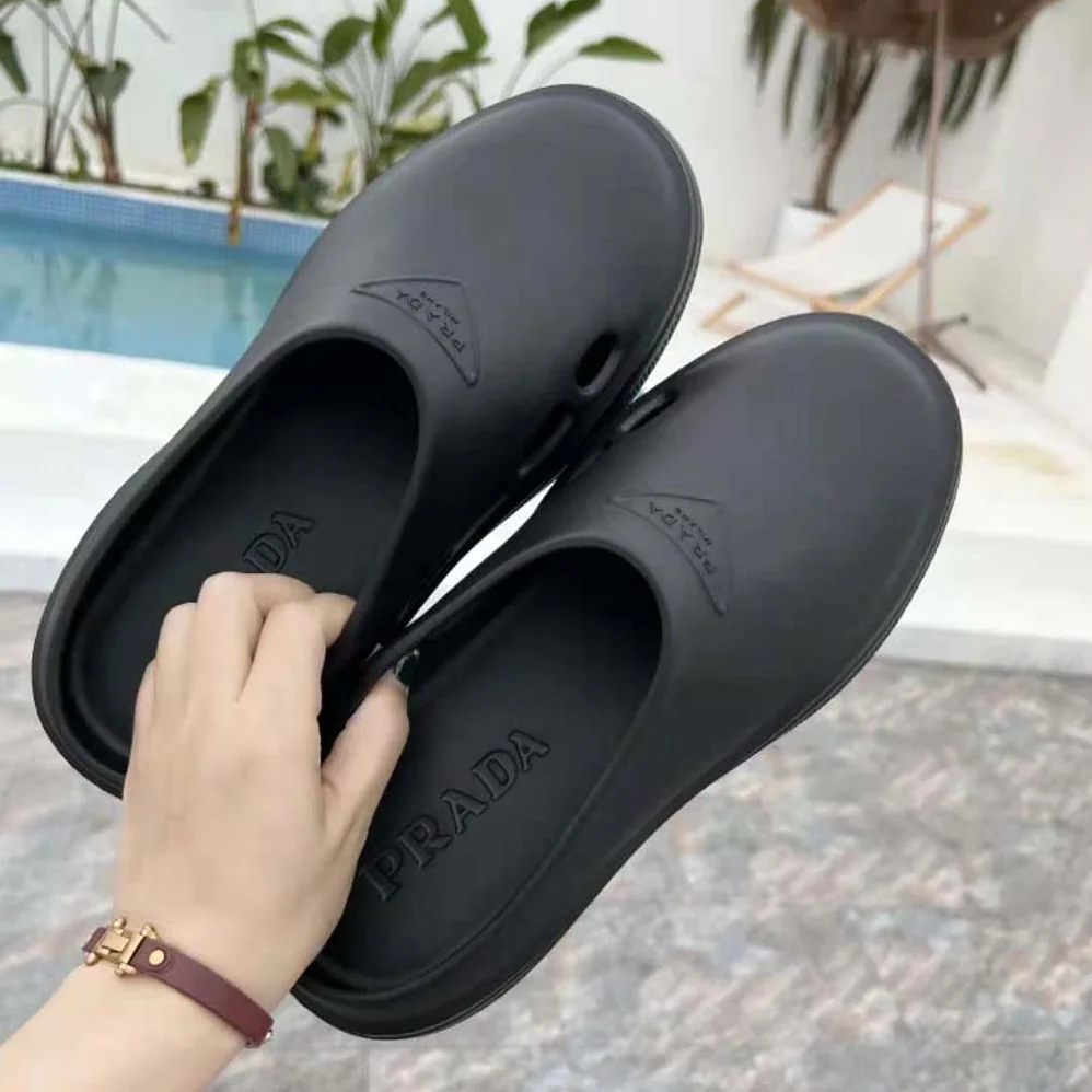 Prada Foam Rubber Mules With Embossed Rubber Triangle Logo for Women in Black Prada Foam Rubber Mules With Embossed Rubber Triangle Logo for Women in Black