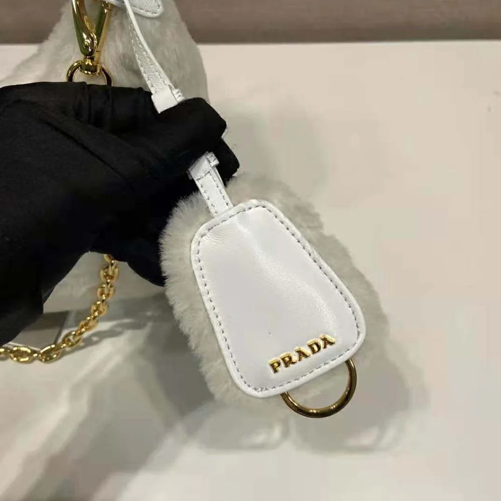 Prada Shearling Mini-Bag with the Enameled Metal Triangle Logo for Women in White Prada Shearling Mini-Bag with the Enameled Metal Triangle Logo for Women in White