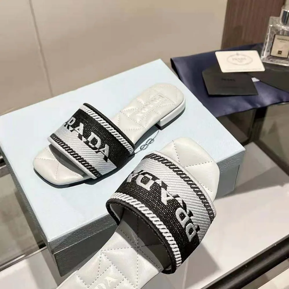 Prada Embroidered Fabric Slides With Embroidered Lettering Logo for Women in White Prada Embroidered Fabric Slides With Embroidered Lettering Logo for Women in White