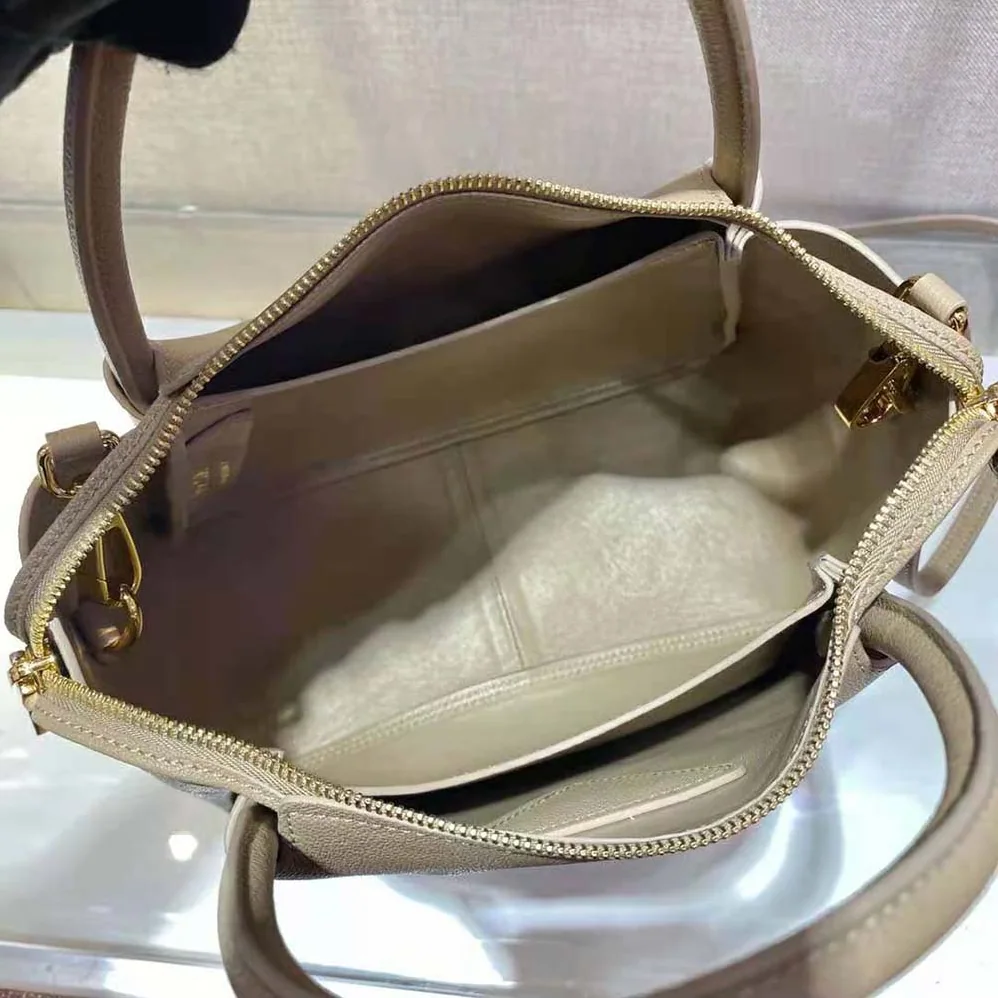 Prada Small leather Handbag with the Prada Metal Lettering Logo Illuminating Its Center for Women in Sandy