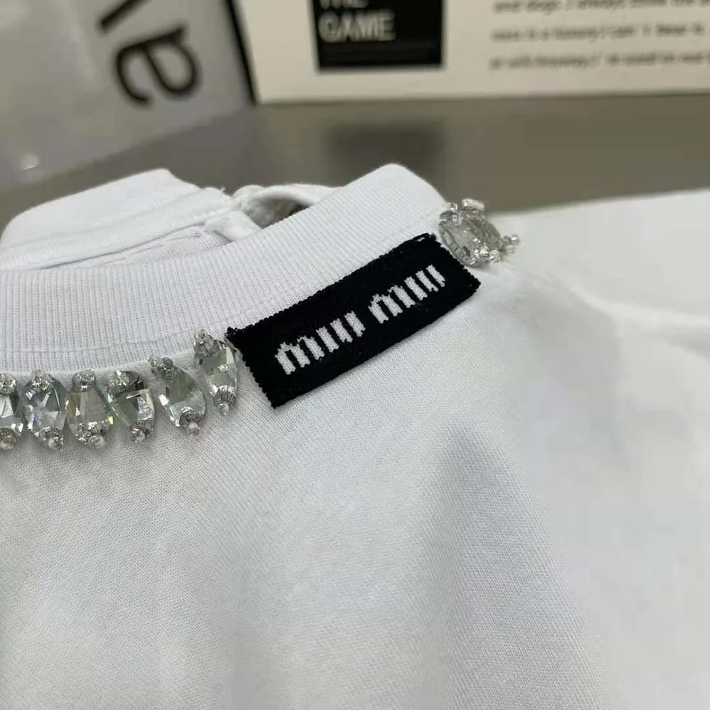 Miu Miu Embroidered Cotton T-shirt with Logo Patch for Women in White Miu Miu Embroidered Cotton T-shirt with Logo Patch for Women in White