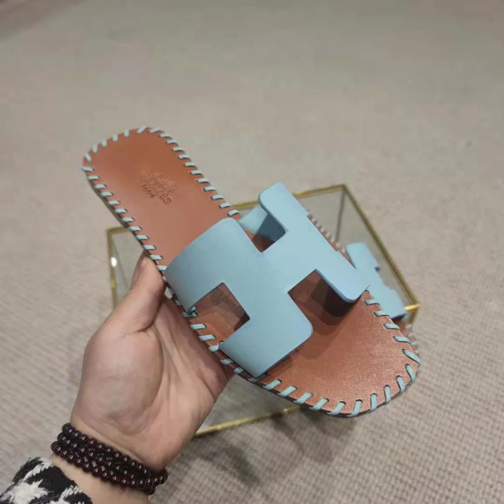 Hermes Oran Sandal in Braided Calfskin with Iconic H Cut-Out for Women in Blue Hermes Oran Sandal in Braided Calfskin with Iconic H Cut-Out for Women in Blue