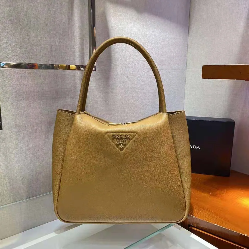 Prada Medium Leather handbag with the Prada Metal Lettering Logo Illuminating Its Center for Women
