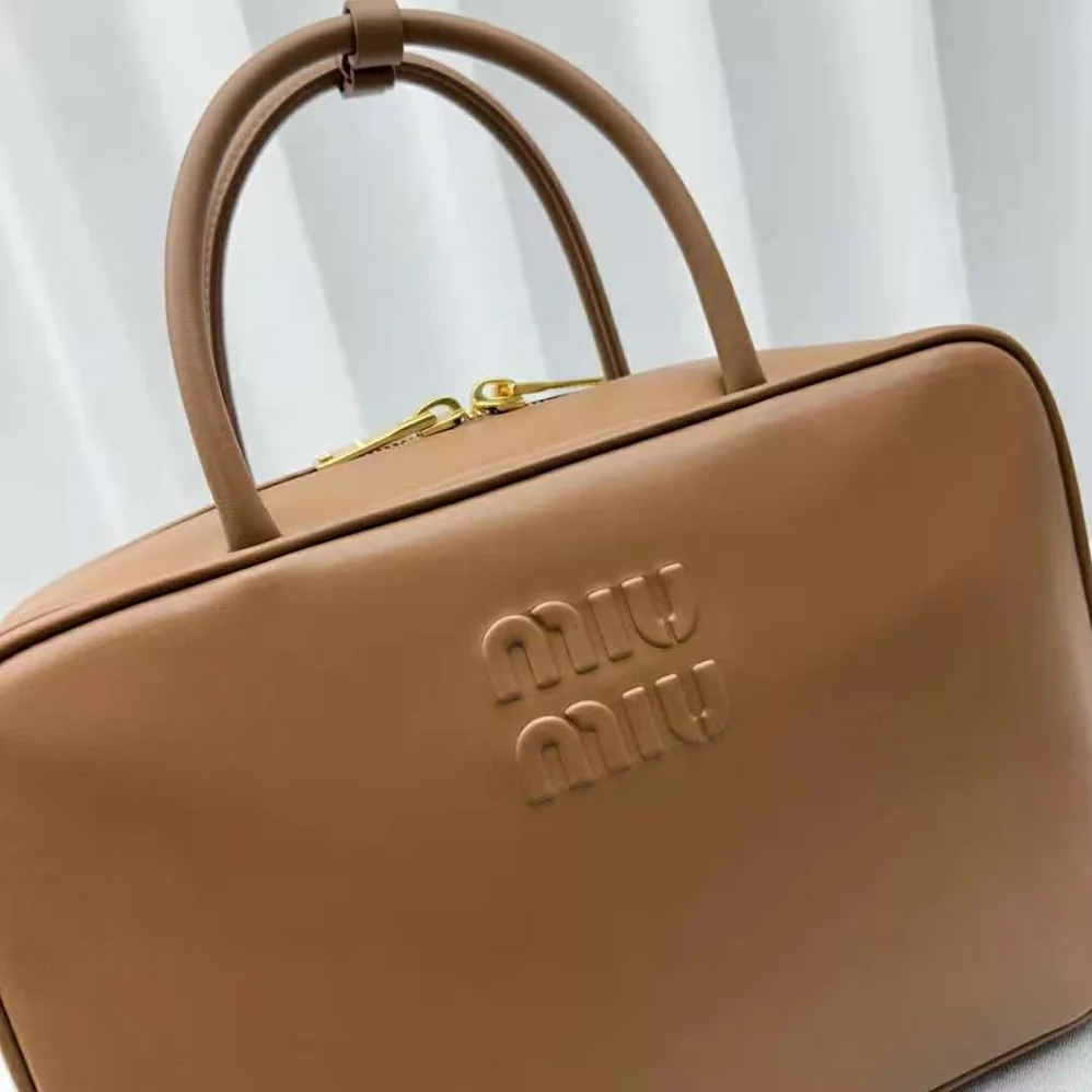 Miu Miu Leather Top-handle Bag with Embossed Lettering Logo for Women in Brown Miu Miu Leather Top-handle Bag with Embossed Lettering Logo for Women in Brown
