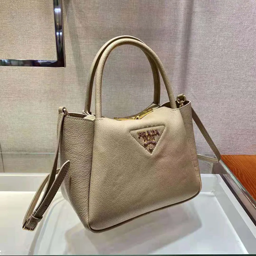 Prada Small leather Handbag with the Prada Metal Lettering Logo Illuminating Its Center for Women in Sandy