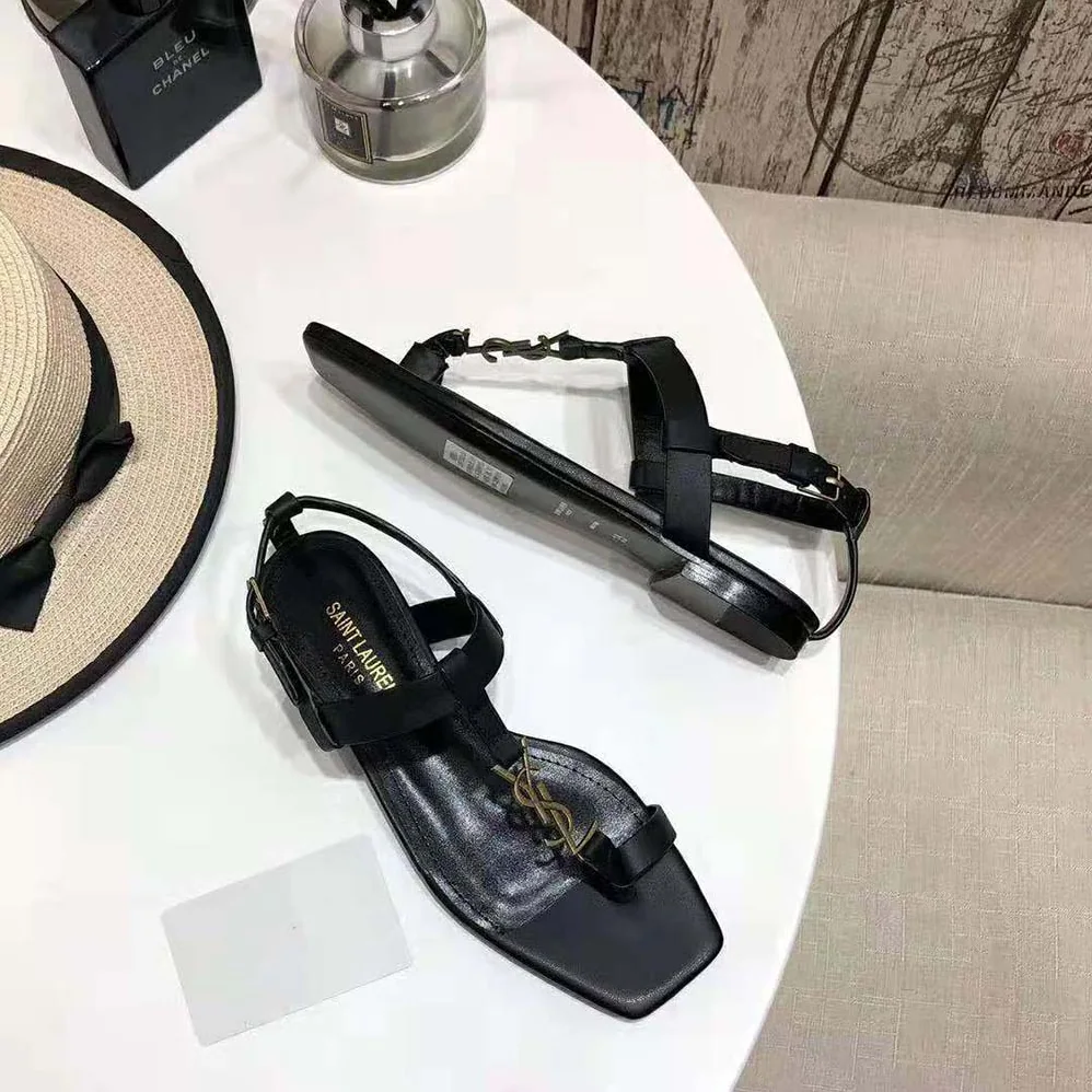 Saint Laurent YSL Cassandra Flat Sandals in Smooth Leather with Gold-tone Monogram for Women in Black