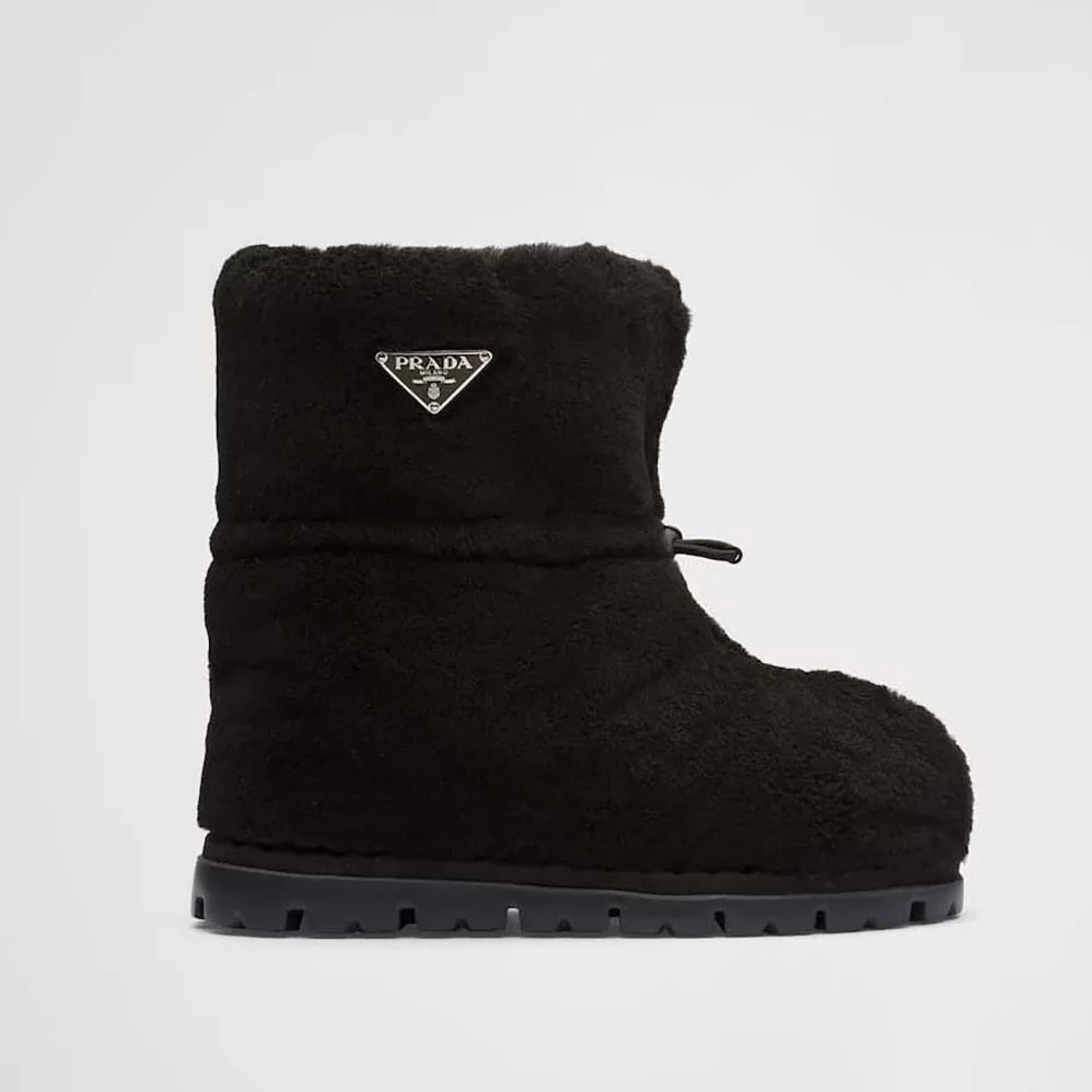 Prada Shearling Booties with Enameled Metal Triangle Logo for Women in Black