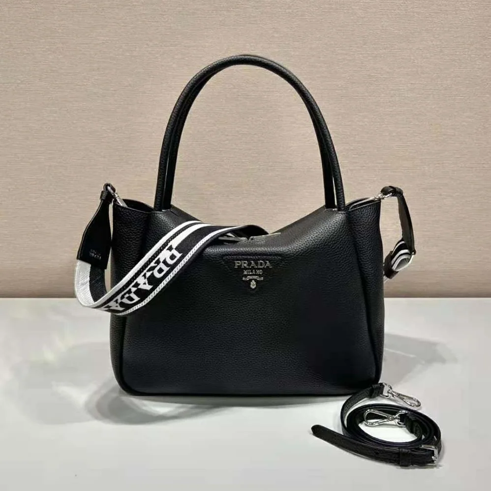 Prada Large Leather Handbag with the Prada Metal Lettering Logo Gleaming at Its Center for Women in Black Prada Large Leather Handbag with the Prada Metal Lettering Logo Gleaming at Its Center for Women in Black