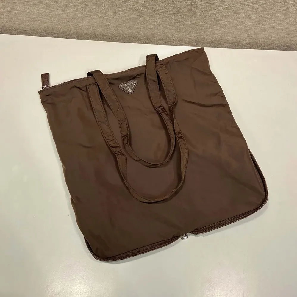 Prada Saffiano Leather Pendant With Re-Nylon Tote Bag for Women in Sienna Prada Saffiano Leather Pendant With Re-Nylon Tote Bag for Women in Sienna