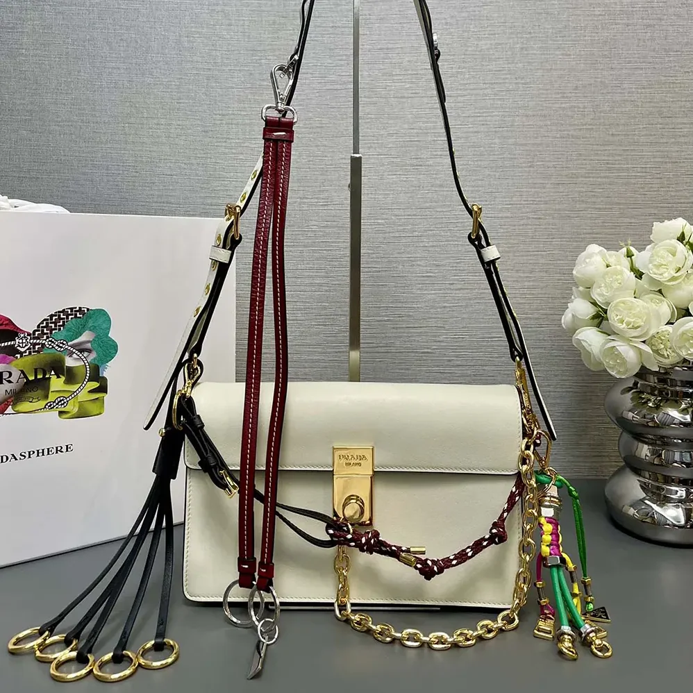 Prada Soft Sound Small Leather Shoulder Bag with Charms for Women in White Prada Soft Sound Small Leather Shoulder Bag with Charms for Women in White