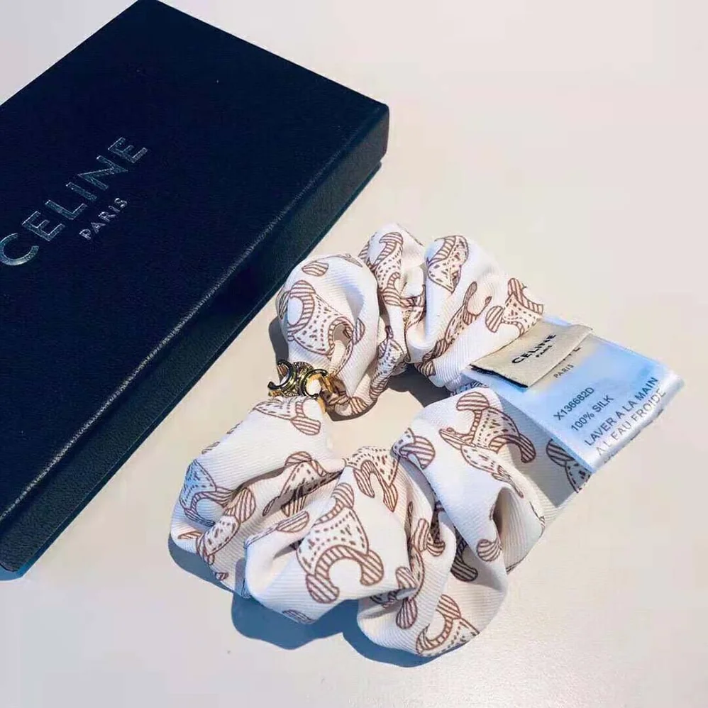 Celine Scrunchy Celine Triomphe Monogram Bracelet in Brass with Gold Finish and White Silk for Women Celine Scrunchy Celine Triomphe Monogram Bracelet in Brass with Gold Finish and White Silk for Women