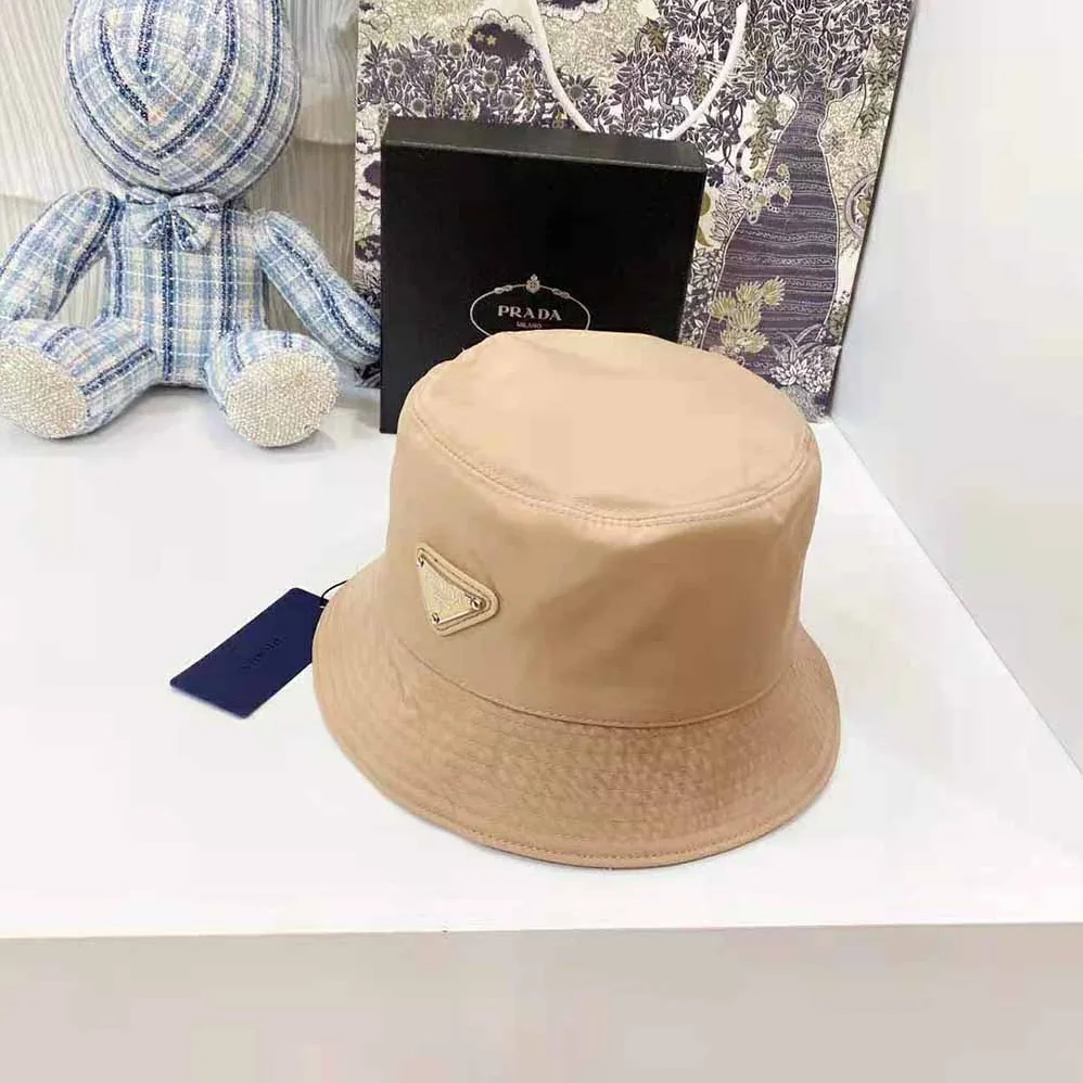 Prada Nylon Bucket Hat Decorated with the Triangle Logo for Women in Sandy Prada Nylon Bucket Hat Decorated with the Triangle Logo for Women in Sandy