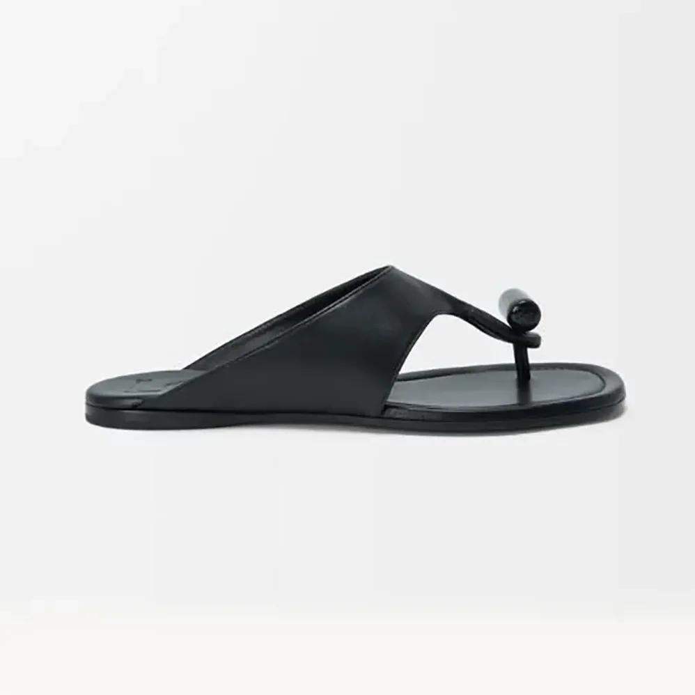 Loewe Toggle Flat Sandal in Shiny Smoot Calfskin for Women in Black Loewe Toggle Flat Sandal in Shiny Smoot Calfskin for Women in Black