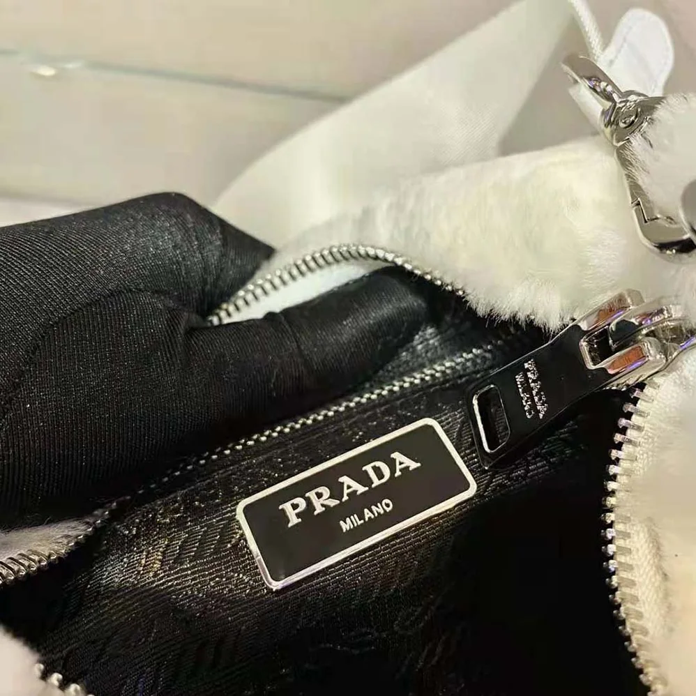 Prada A Patchwork-style Triangle Motif Characterizes Shearling Shoulder Bag for Women Prada A Patchwork-style Triangle Motif Characterizes Shearling Shoulder Bag for Women