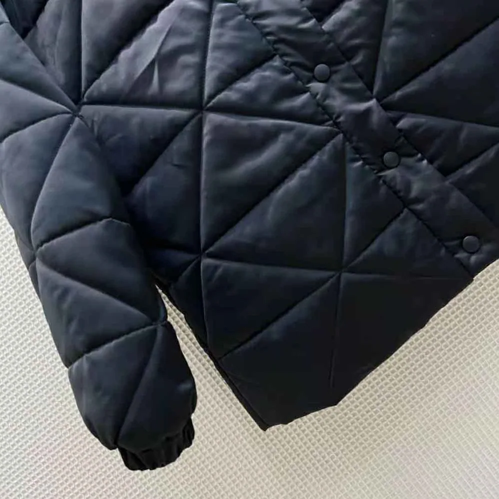 Prada Emblematic Triangle Quilted Re-Nylon Jacket for Women in Black Prada Emblematic Triangle Quilted Re-Nylon Jacket for Women in Black