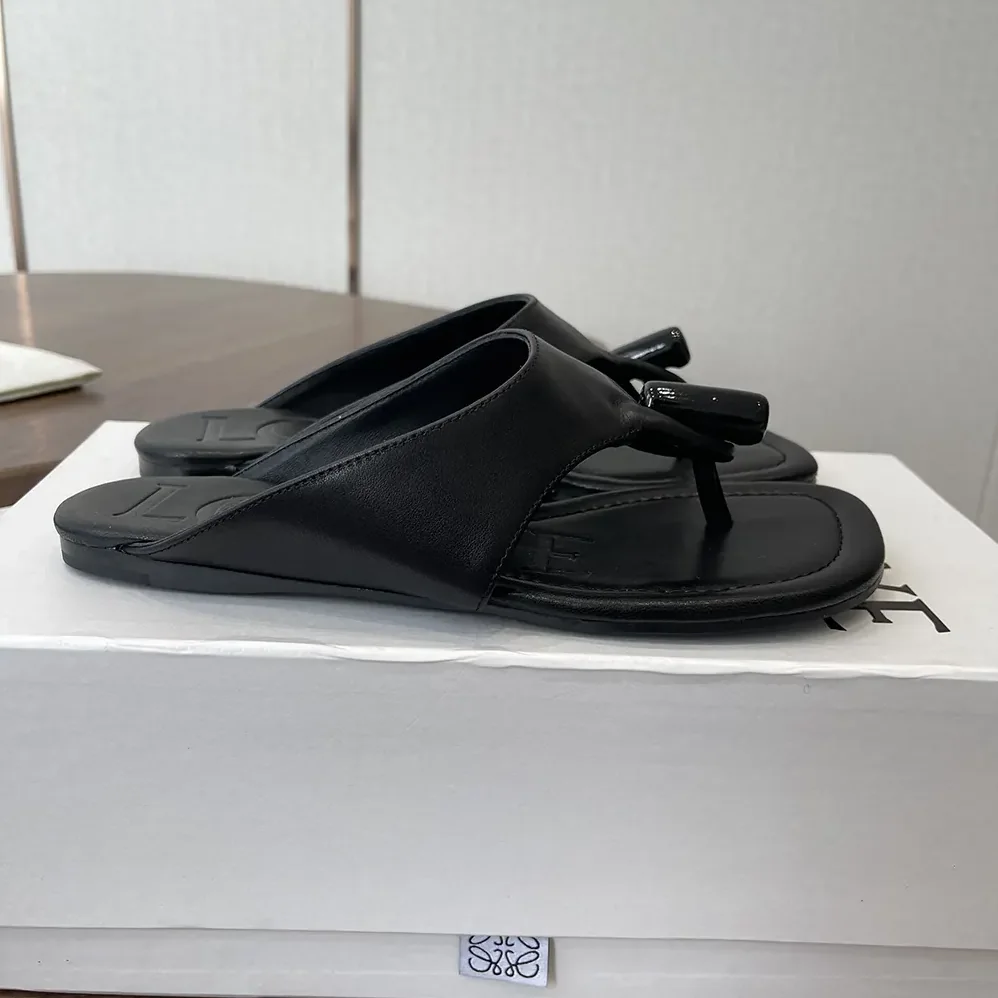 Loewe Toggle Flat Sandal in Shiny Smoot Calfskin for Women in Black Loewe Toggle Flat Sandal in Shiny Smoot Calfskin for Women in Black