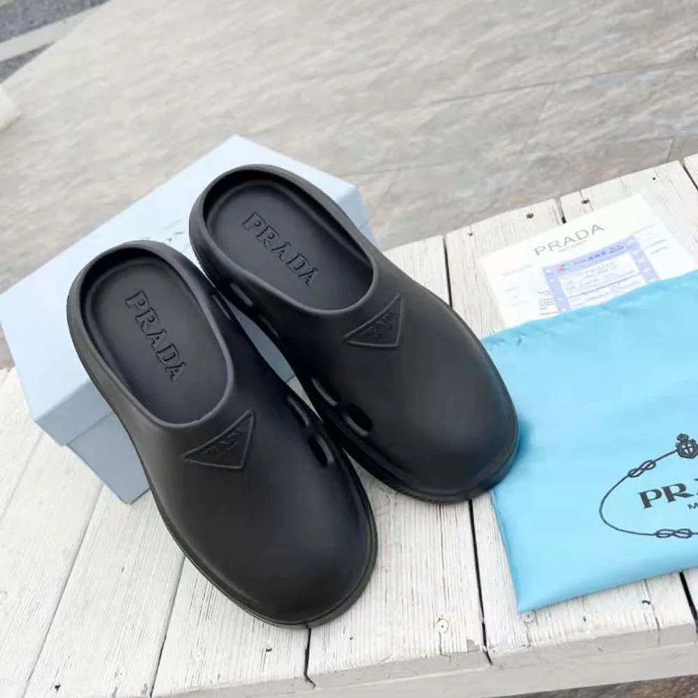 Prada Foam Rubber Mules With Embossed Rubber Triangle Logo for Women in Black Prada Foam Rubber Mules With Embossed Rubber Triangle Logo for Women in Black