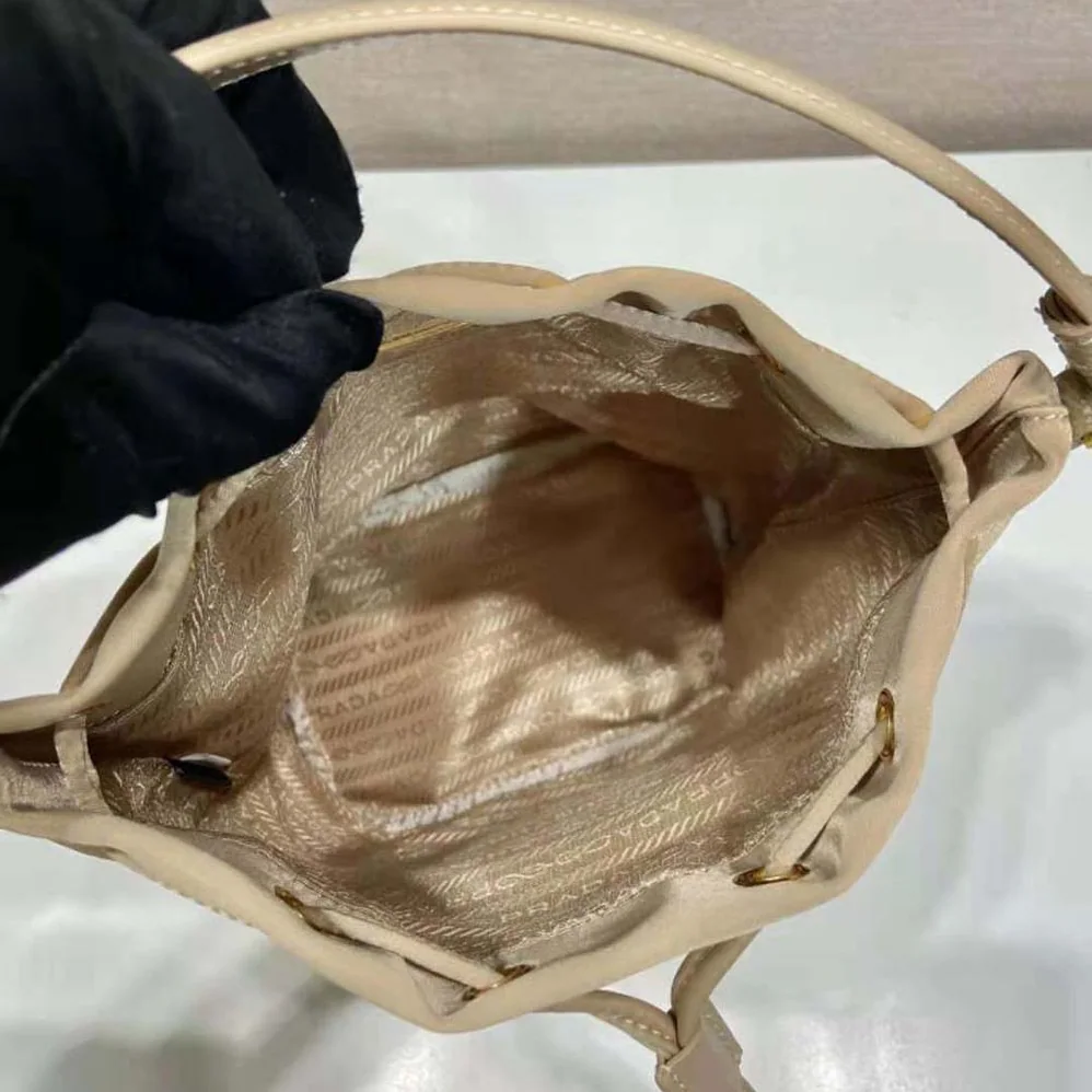 Prada Duet Re-Nylon Bucket Bag for Women in Beige