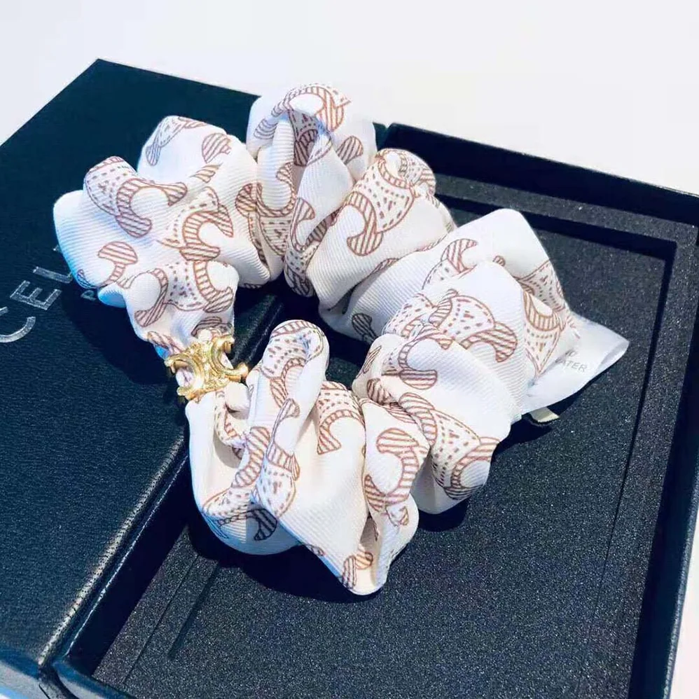 Celine Scrunchy Celine Triomphe Monogram Bracelet in Brass with Gold Finish and White Silk for Women Celine Scrunchy Celine Triomphe Monogram Bracelet in Brass with Gold Finish and White Silk for Women