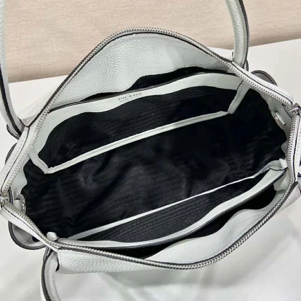 Prada Large Leather Handbag with the Prada Metal Lettering Logo Gleaming at Its Center for Women in White Prada Large Leather Handbag with the Prada Metal Lettering Logo Gleaming at Its Center for Women in White