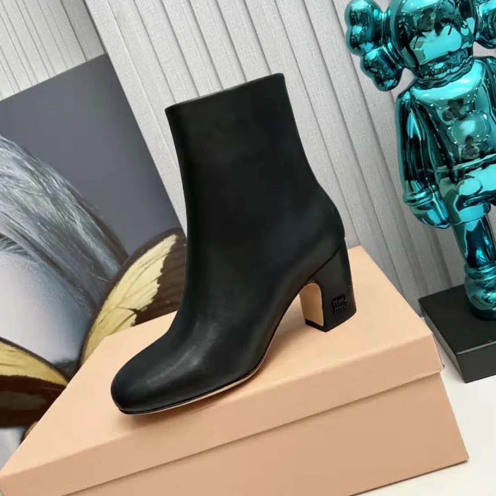 Miu Miu Leather Booties with Metal Lettering Logo for Women in Black