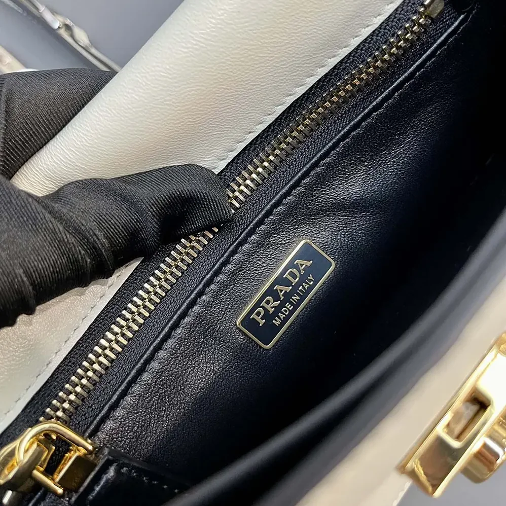 Prada Soft Sound Small Leather Shoulder Bag with Charms for Women in White Prada Soft Sound Small Leather Shoulder Bag with Charms for Women in White