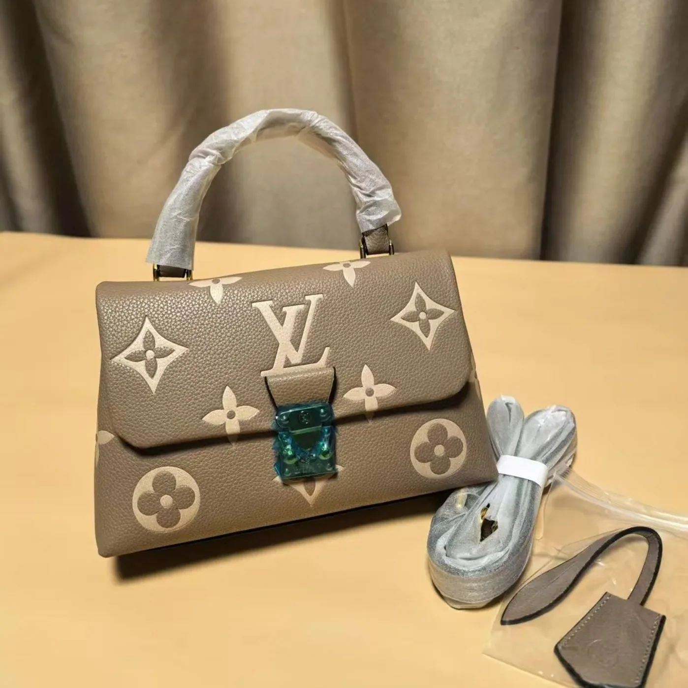Louis Vuitton Madeleine BB Monogram Empreinte Dove Gray in Creme Beige