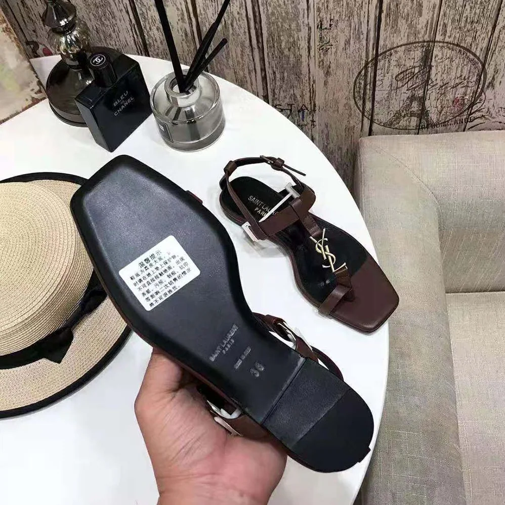 Saint Laurent YSL Cassandra Flat Sandals in Smooth Leather with Gold-Tone Monogram for Women in Brown