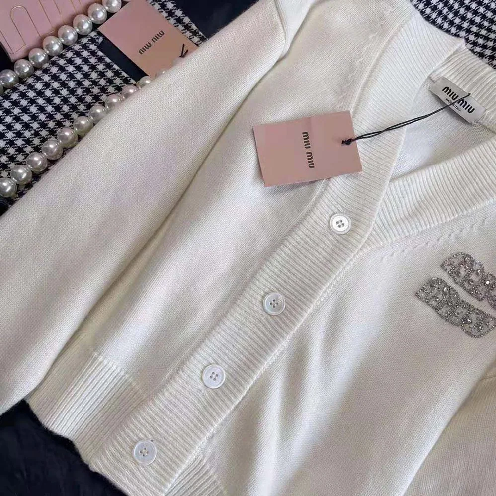 Miu Miu Cashmere Cardigan Features an Embroidered Logo for Women in White Miu Miu Cashmere Cardigan Features an Embroidered Logo for Women in White