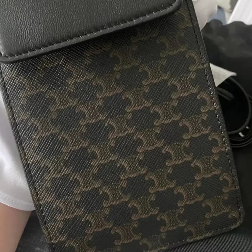Celine Phone Pouch with Flap in Triomphe Canvas and Lambskin for Women in Black Celine Phone Pouch with Flap in Triomphe Canvas and Lambskin for Women in Black