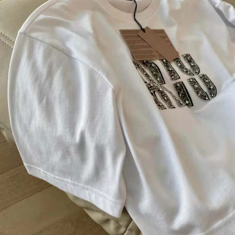 Miu Miu Embroidered Cotton T-shirt with Embroidered Logo for Women in White Miu Miu Embroidered Cotton T-shirt with Embroidered Logo for Women in White