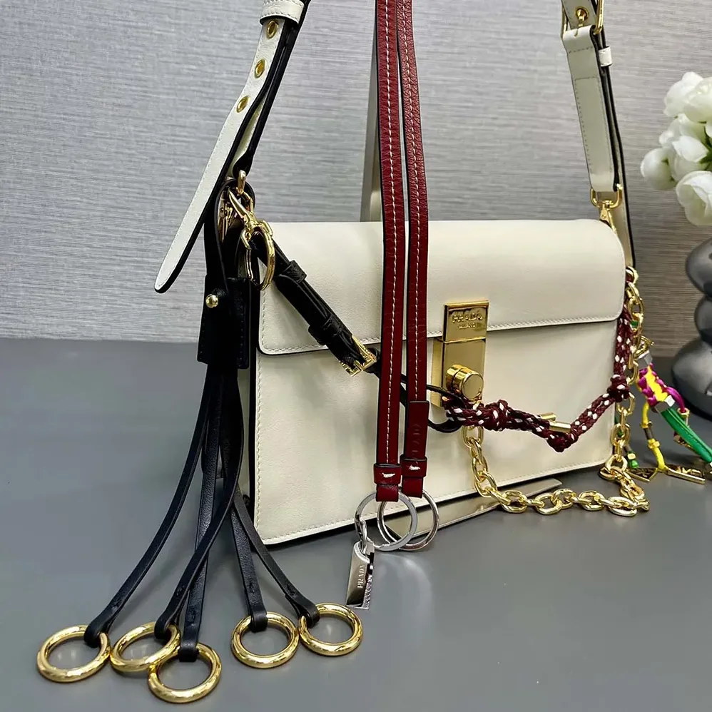 Prada Soft Sound Small Leather Shoulder Bag with Charms for Women in White Prada Soft Sound Small Leather Shoulder Bag with Charms for Women in White