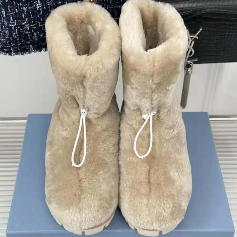 Prada Shearling Booties with Enameled Metal Triangle Logo for Women in Beige