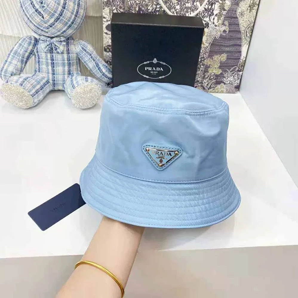Prada Nylon Bucket Hat Decorated with the Triangle Logo for Women in Blue Prada Nylon Bucket Hat Decorated with the Triangle Logo for Women in Blue