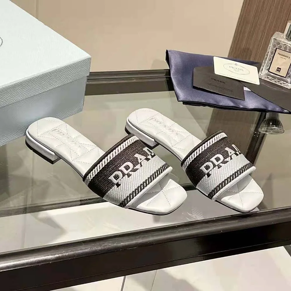 Prada Embroidered Fabric Slides With Embroidered Lettering Logo for Women in White Prada Embroidered Fabric Slides With Embroidered Lettering Logo for Women in White