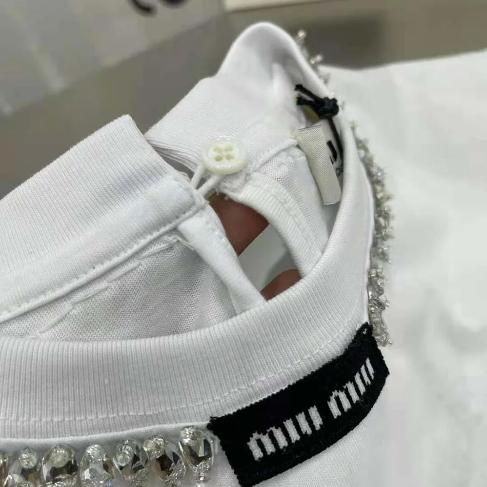 Miu Miu Embroidered Cotton T-shirt with Logo Patch for Women in White Miu Miu Embroidered Cotton T-shirt with Logo Patch for Women in White