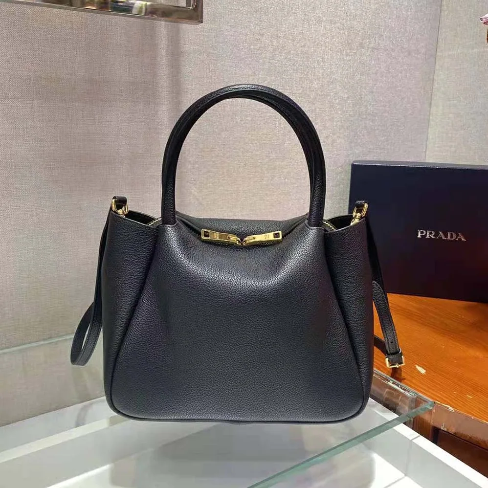 Prada Small leather Handbag with the Prada Metal Lettering Logo Illuminating Its Center for Women Prada Small leather Handbag with the Prada Metal Lettering Logo Illuminating Its Center for Women