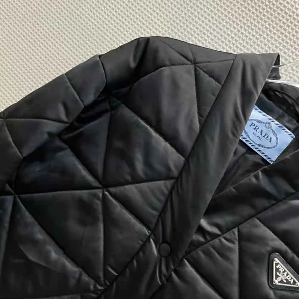 Prada Emblematic Triangle Quilted Re-Nylon Jacket for Women in Black Prada Emblematic Triangle Quilted Re-Nylon Jacket for Women in Black