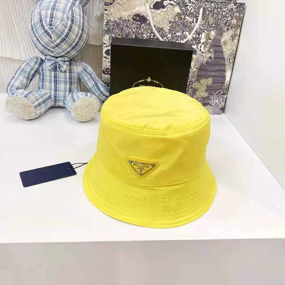 Prada Nylon Bucket Hat Decorated with the Triangle Logo for Women in Yellow