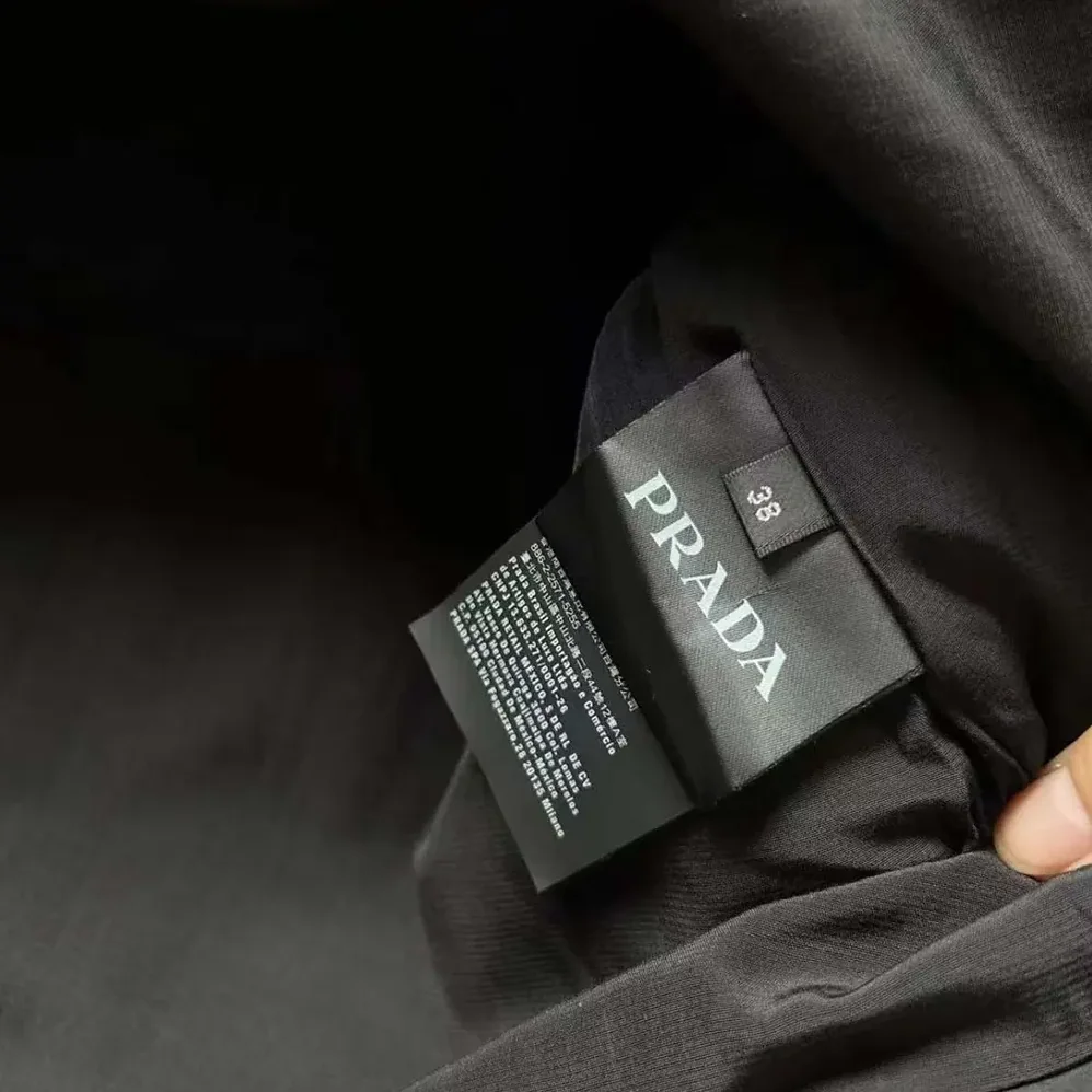 Prada Re-Nylon Mini-dress with Metal Triangle Logo for Women in Black Prada Re-Nylon Mini-dress with Metal Triangle Logo for Women in Black