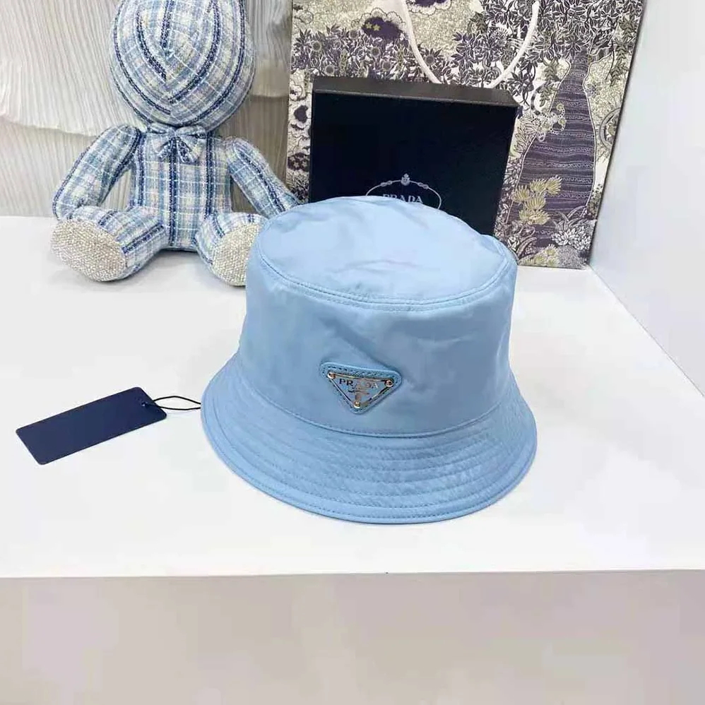 Prada Nylon Bucket Hat Decorated with the Triangle Logo for Women in Blue Prada Nylon Bucket Hat Decorated with the Triangle Logo for Women in Blue